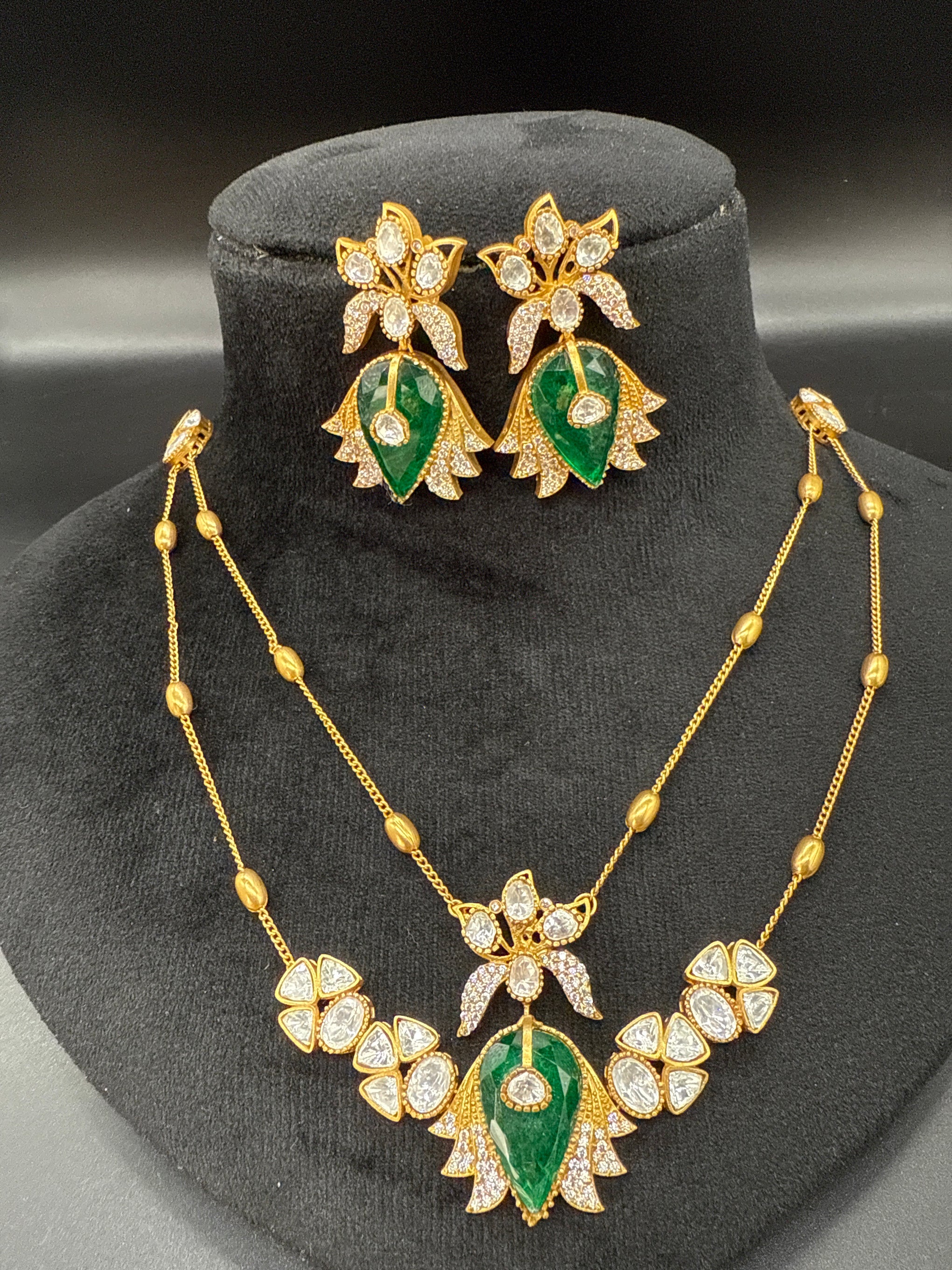 Two layered stepchain emerald and mozonite stone pendent set with earrings