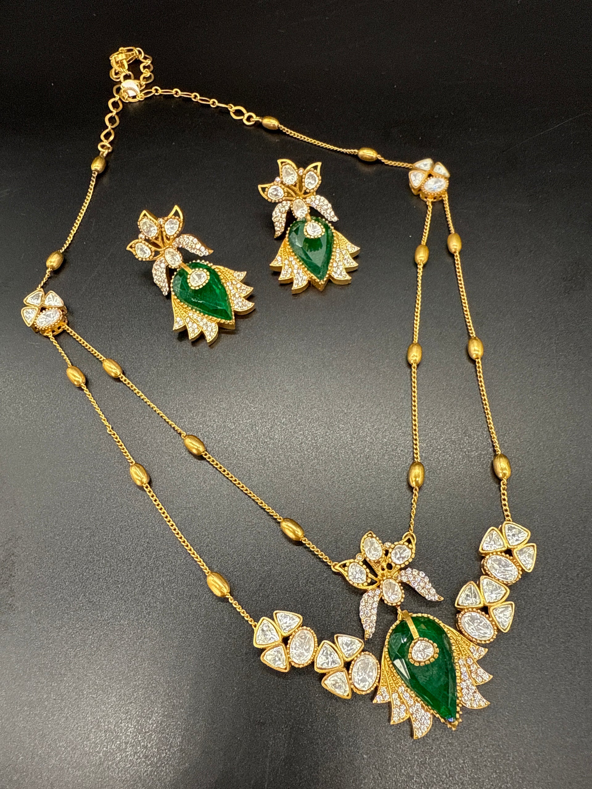 Two layered stepchain emerald and mozonite stone pendent set with earrings