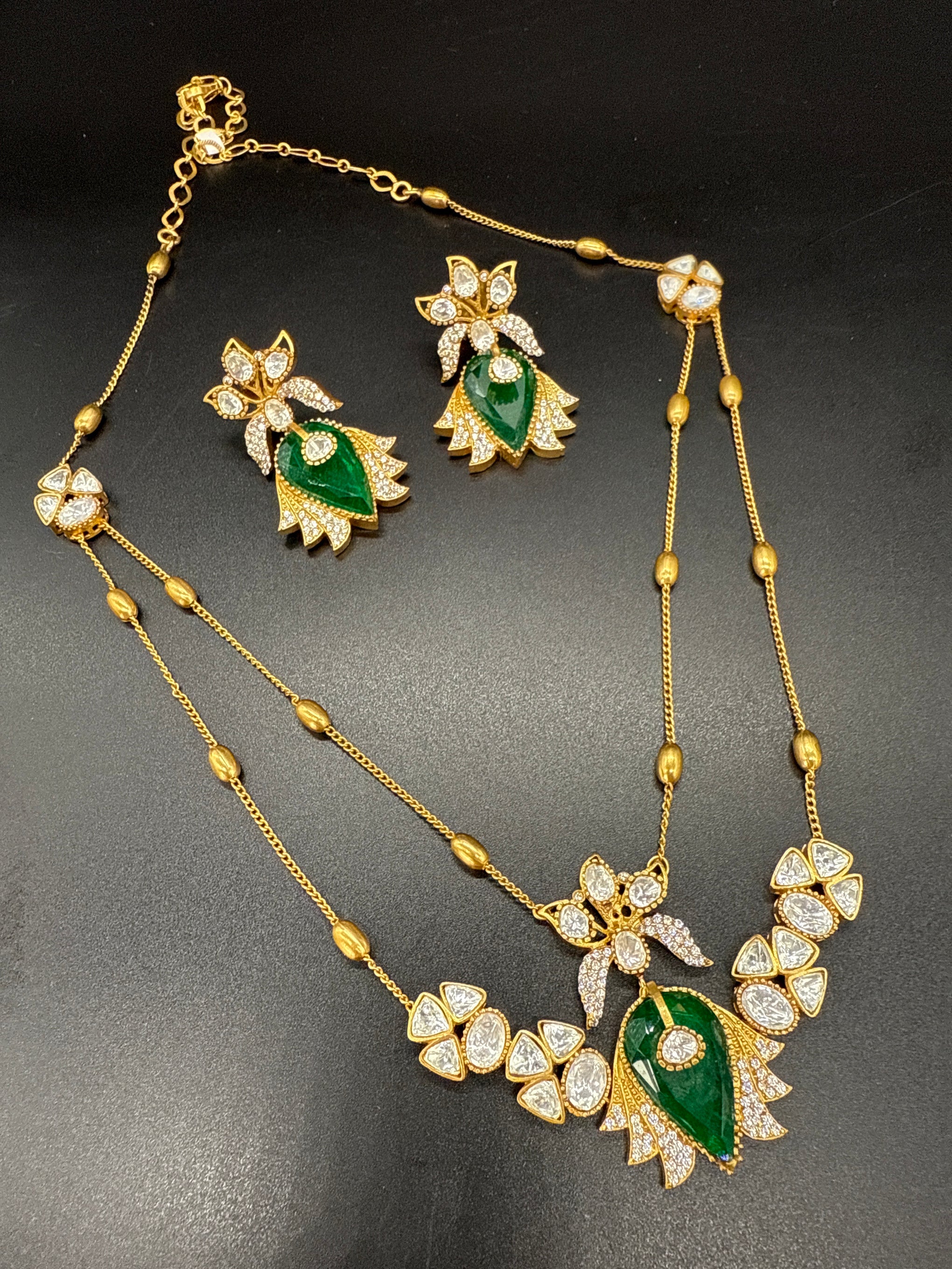 Two layered stepchain emerald and mozonite stone pendent set with earrings