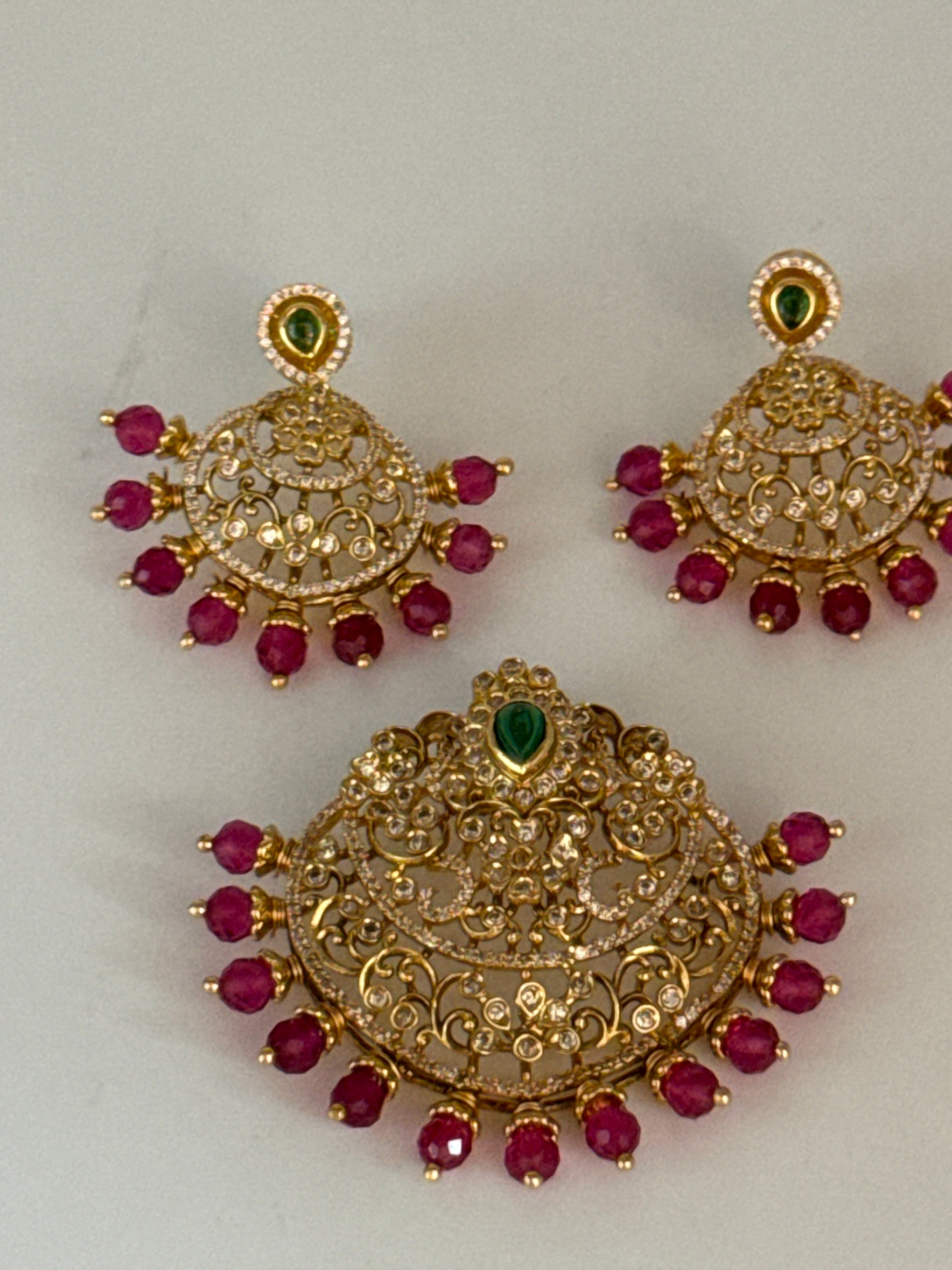 Uncut stones pendant set in ruby beads